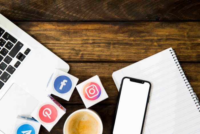 elevated-view-coffee-notepad-with-electronic-gadgets-media-icons (1) social media tools
